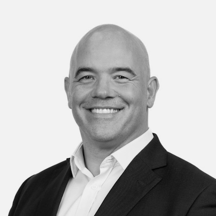 Headshot of Chris Elwell Sutton, greyscale